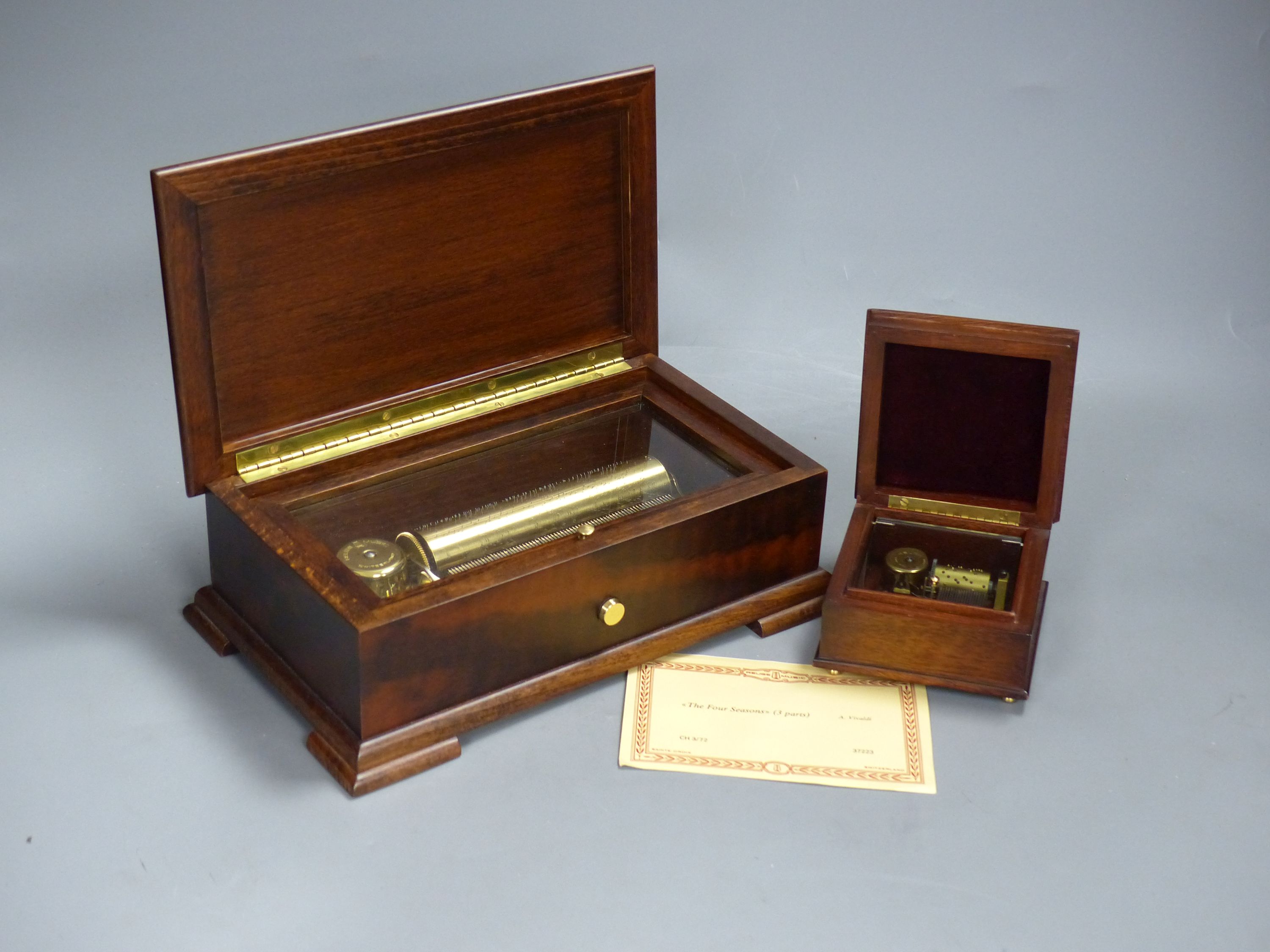 A Swiss Reuge St Croix marquetry and walnut cylinder music box, playing 'The Four Seasons' and a similar small square music box